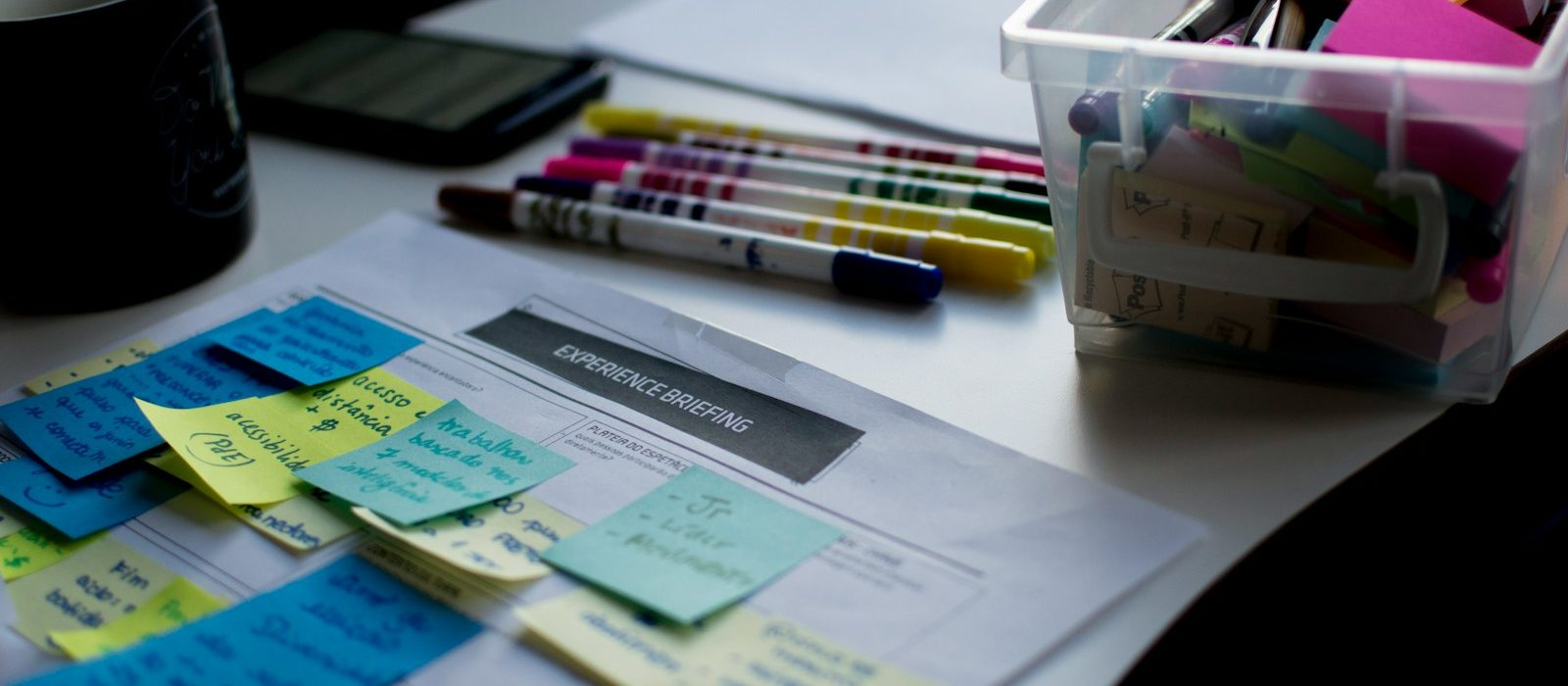 Photo by Felipe Furtado sticky notes on paper document beside pens and box